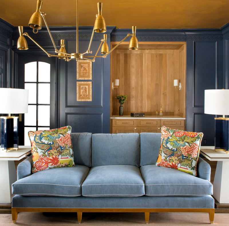 Blue mohair sofa in study area with bronze chandelier
