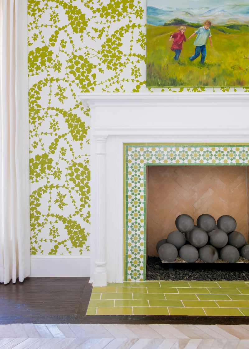Photo of tiled fireplace with green printed walls