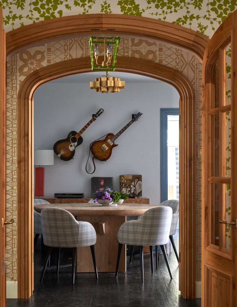 View of round table with guitars hanging on wall