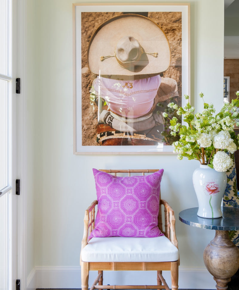 Photo of cane backed side chair with photograph hanging above it