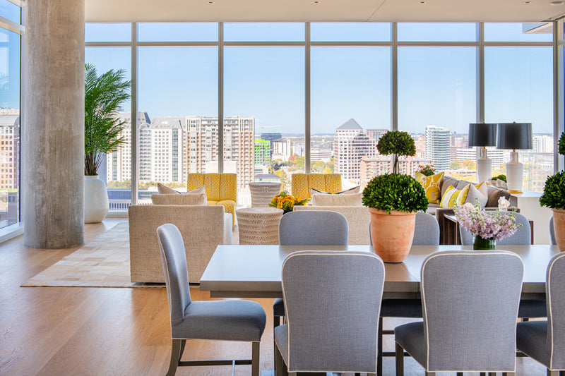 Photo of High Rise dining area near large floor to ceiling windows looking over city