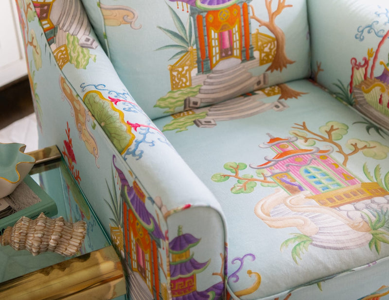 Close up of upholstered chair with chinoiserie inspired fabric