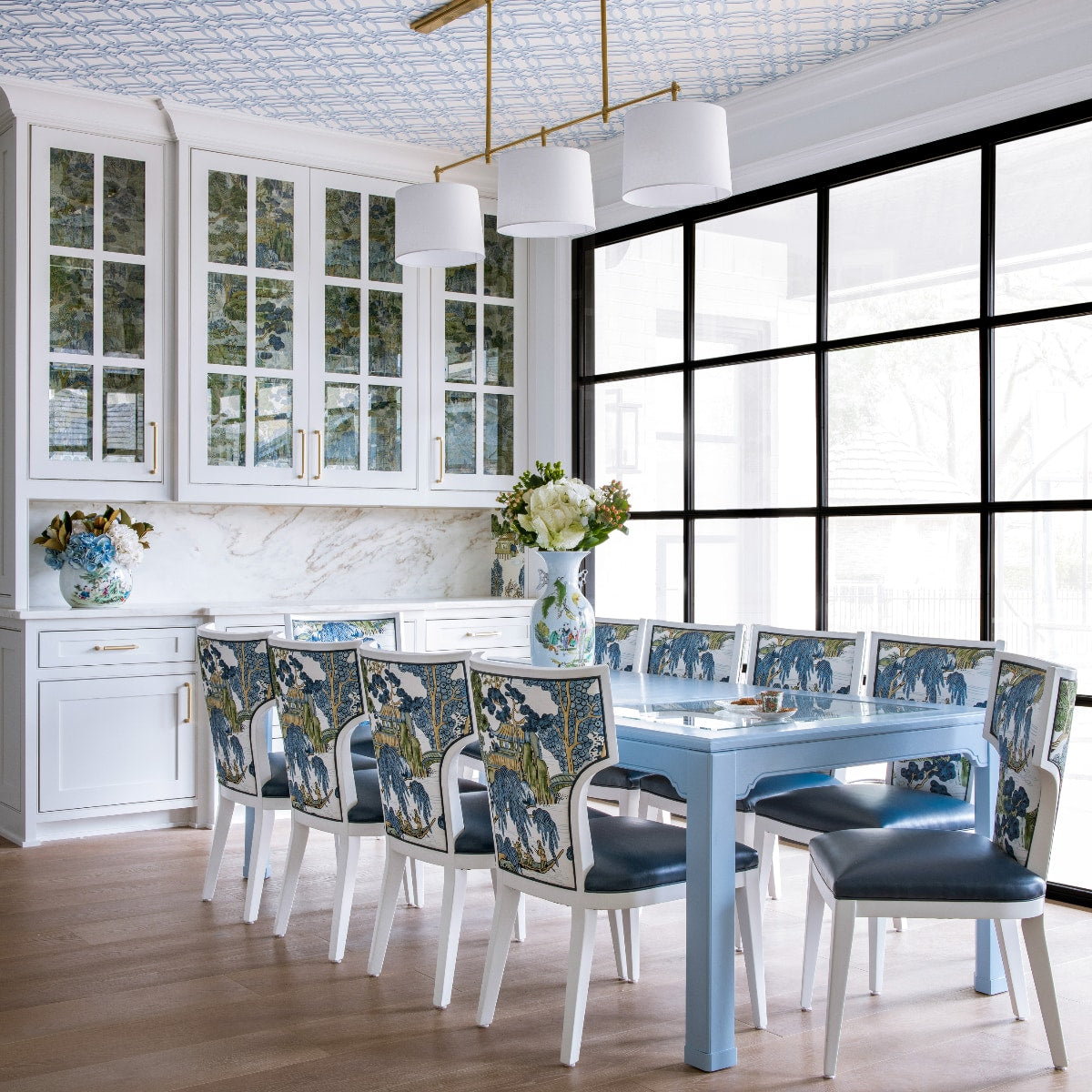 Dining area with blue table and painted back dining chairs