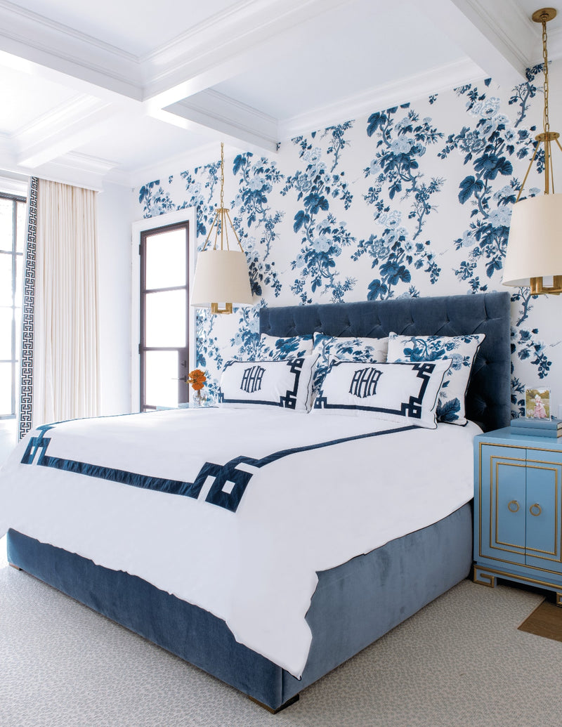 Bed area with blue flowers wallcovering