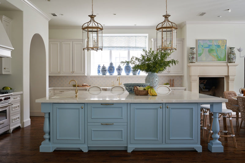 Large kitchen area with marble topped blue island