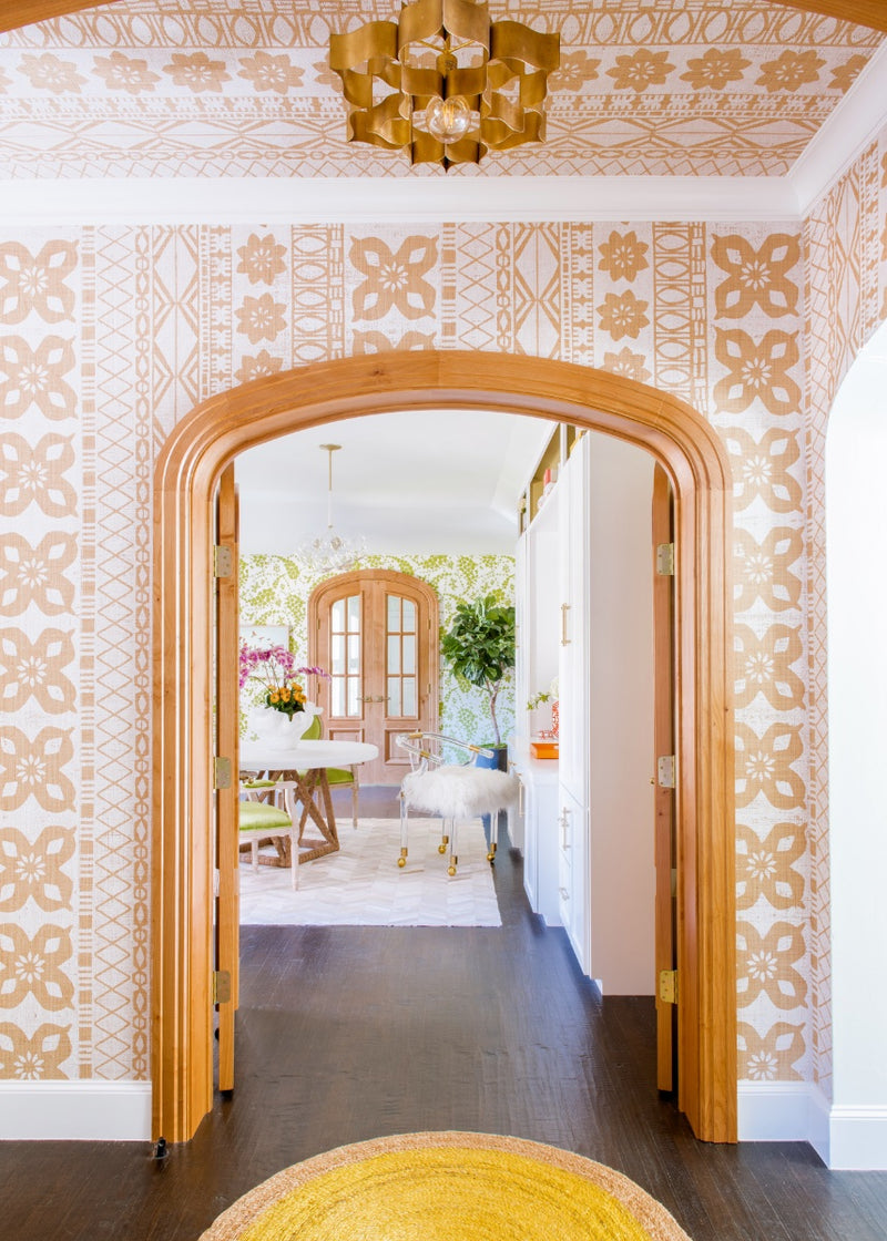 View of walkway into dining area with orange printed wallcovering