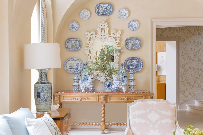 Living area wall with console table and decorative plates on wall