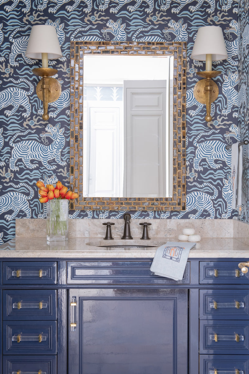 Sink with blue lacquer cabinets and blue tiger wallcovering
