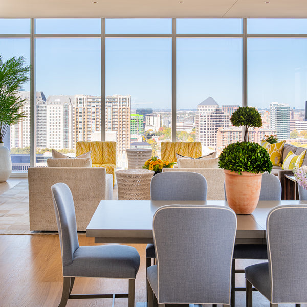 Photo of High Rise dining area near large floor to ceiling windows looking over city