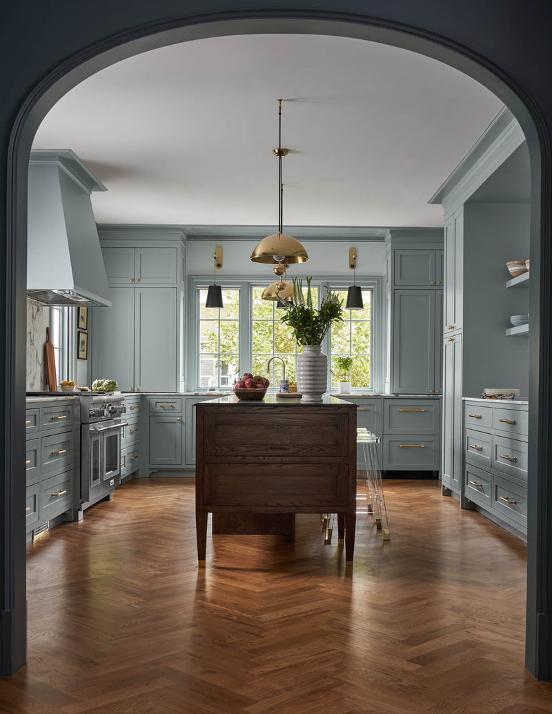 View of kitchen area with blue cabinets and kitchen island