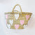 Woven top handle tote with pink and white hearts stitched on the bag